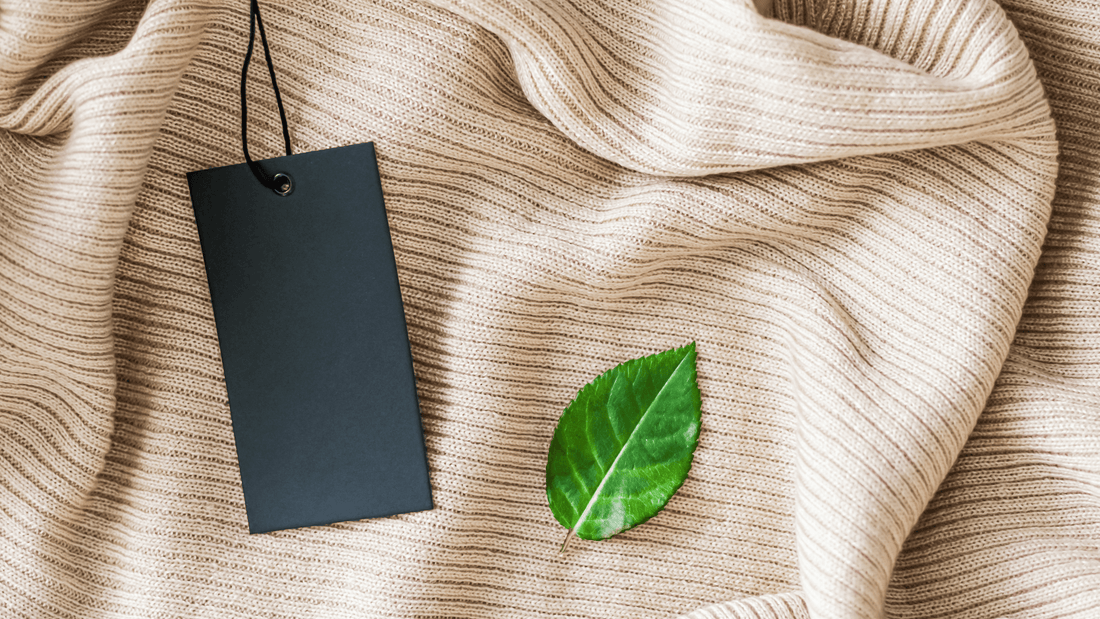 image of a fabric in beige colour with a leaf and a tag